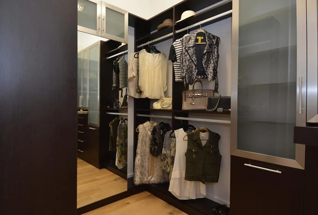 A custom media center wall with built-in shelving and concealed storage