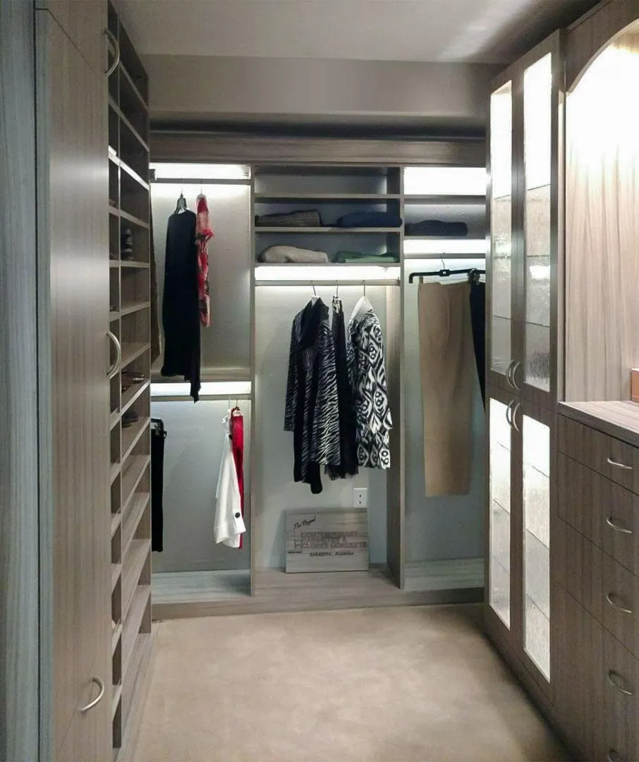 Soft gray custom walk-in closet with drawers and hanging