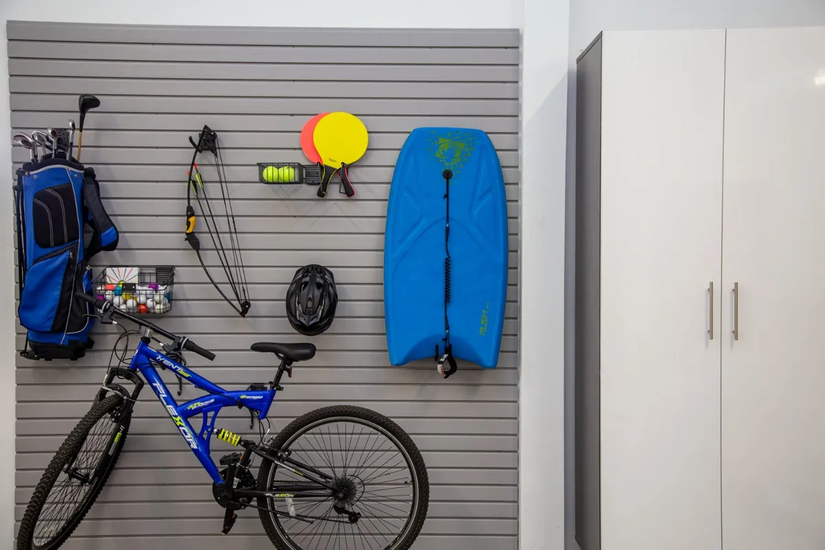 Garage slatwall organizing sports and yard equipment