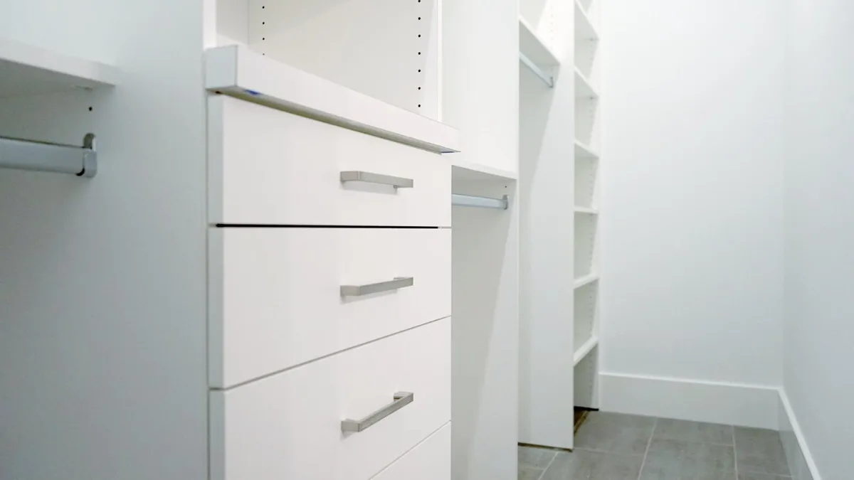 A custom home office with built-in desk and floor-to-ceiling shelving