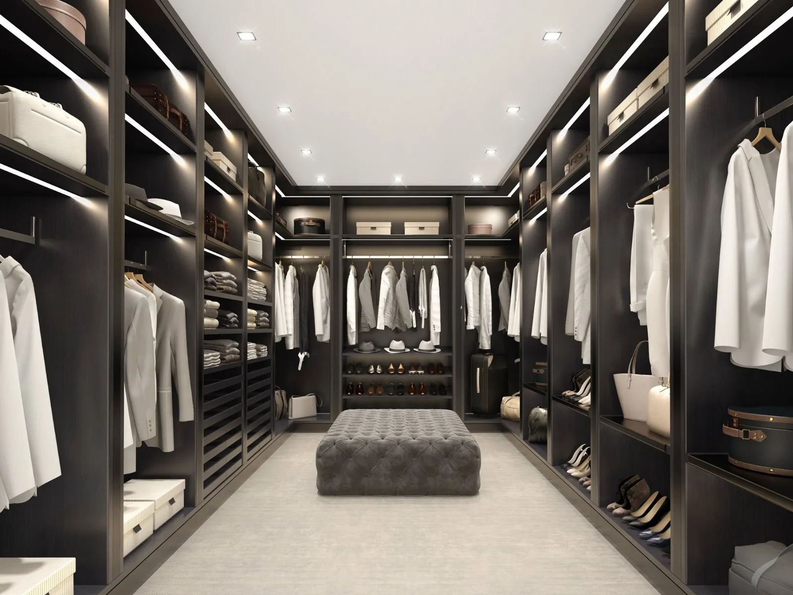 A custom-organized SpaceCraft walk-in closet with an island and LED lighting